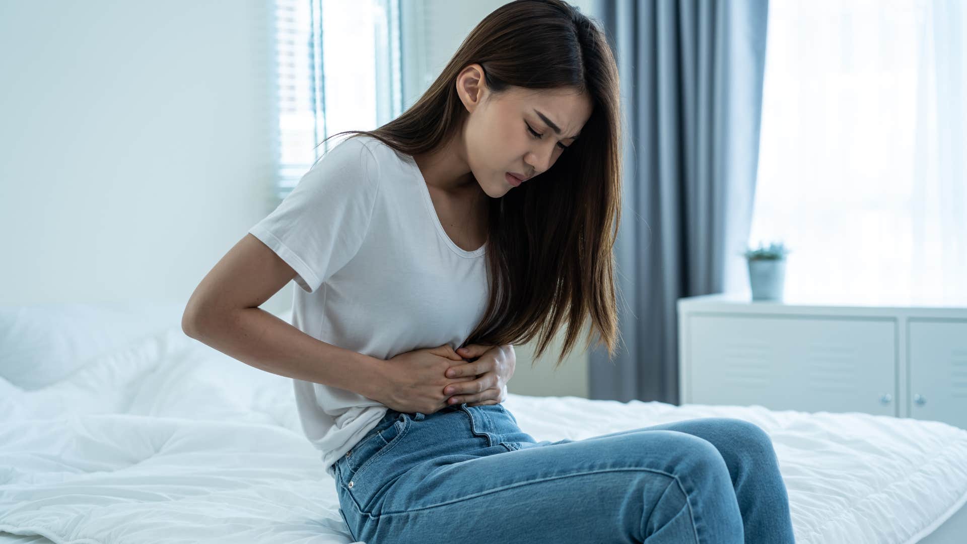 woman in pain holding her stomach