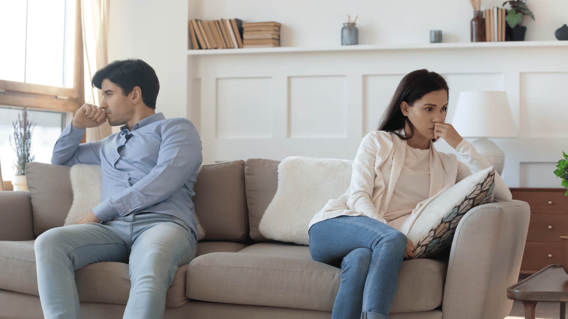 couple sitting on couch not talking