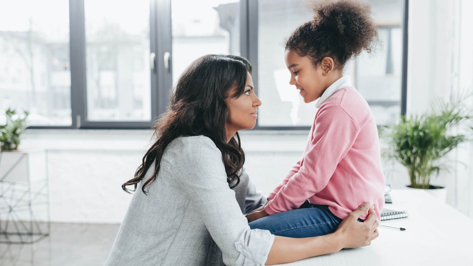 mom talking to daughter on counter