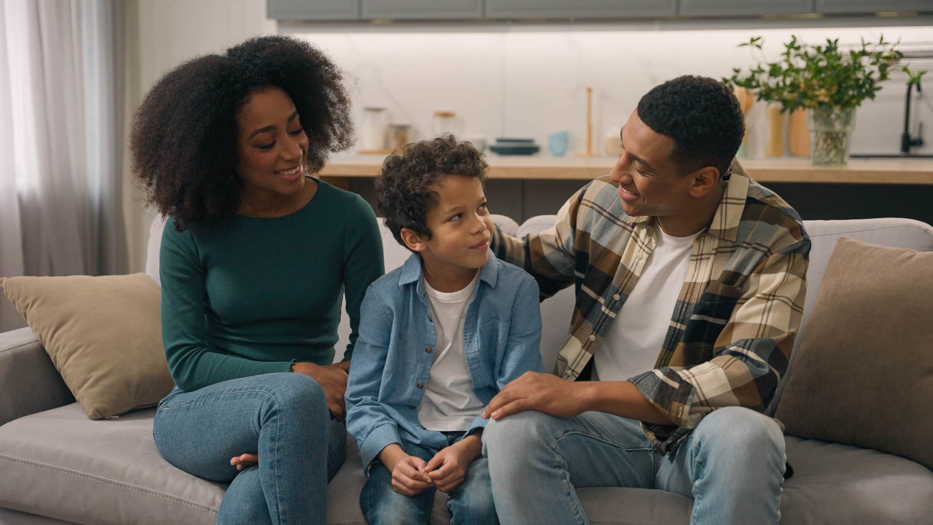 parents talking to son on couch