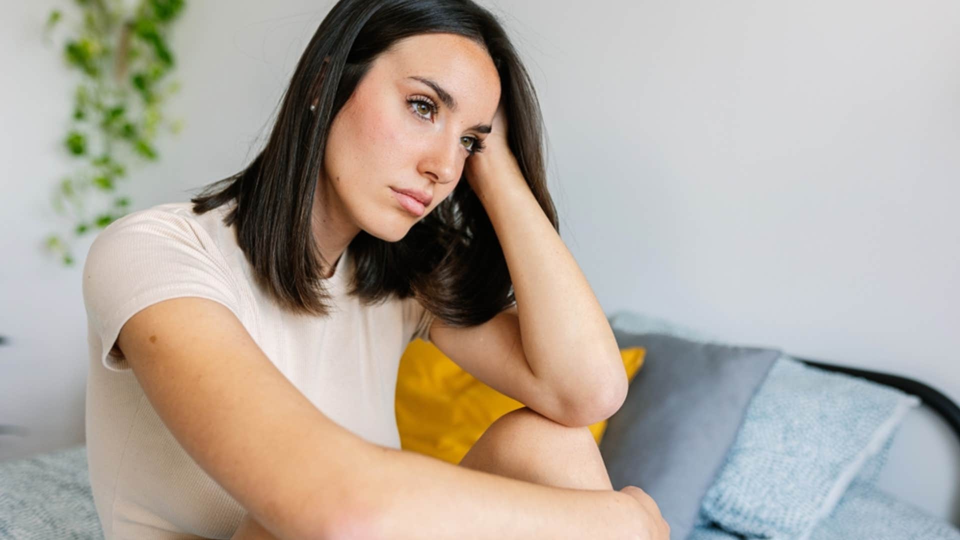 depressed woman sitting on couch