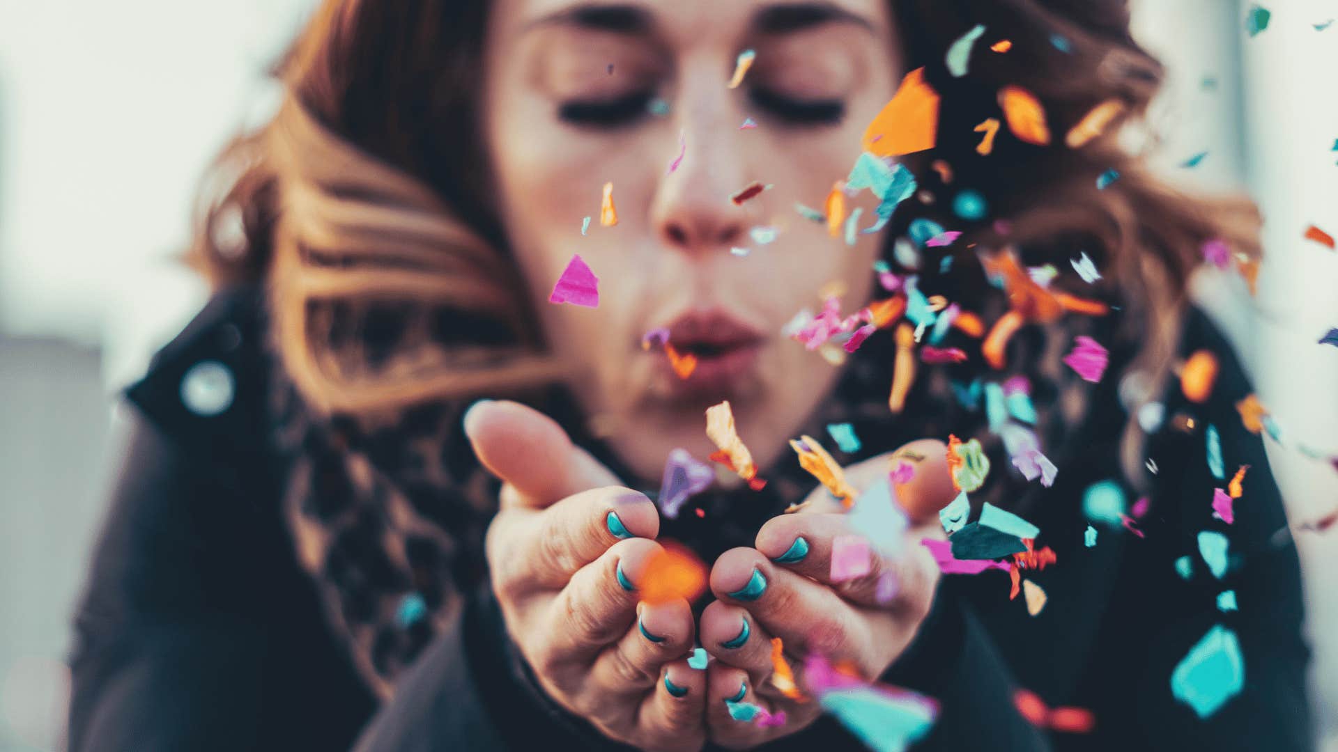 woman blowing confetti