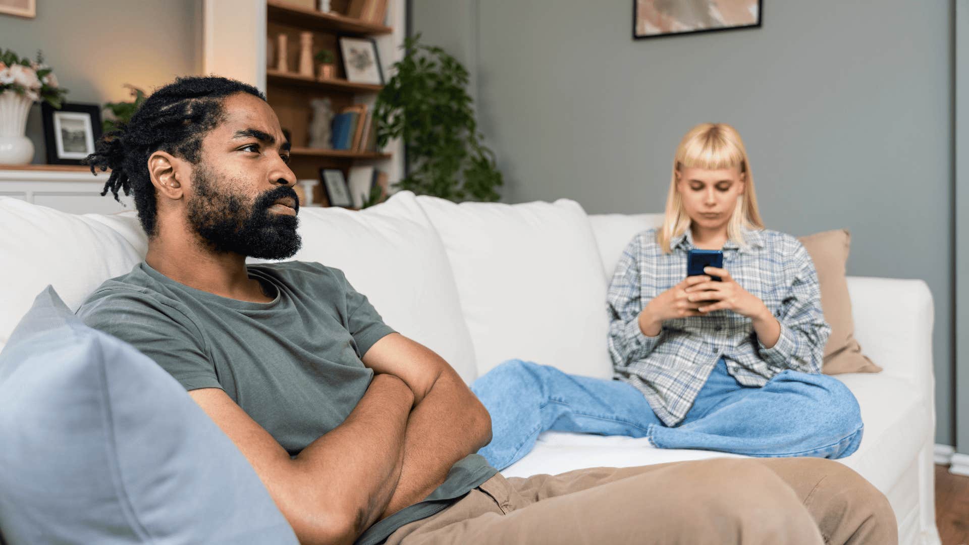 couple sitting on couch together not communicating