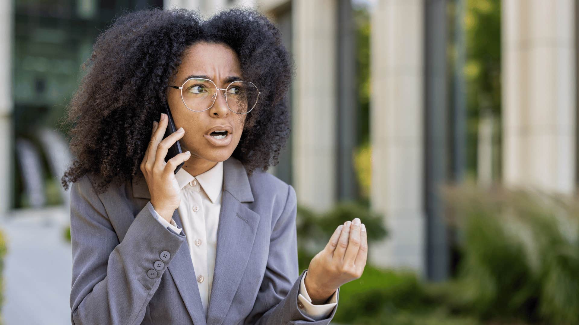 serious woman speaking on the phone