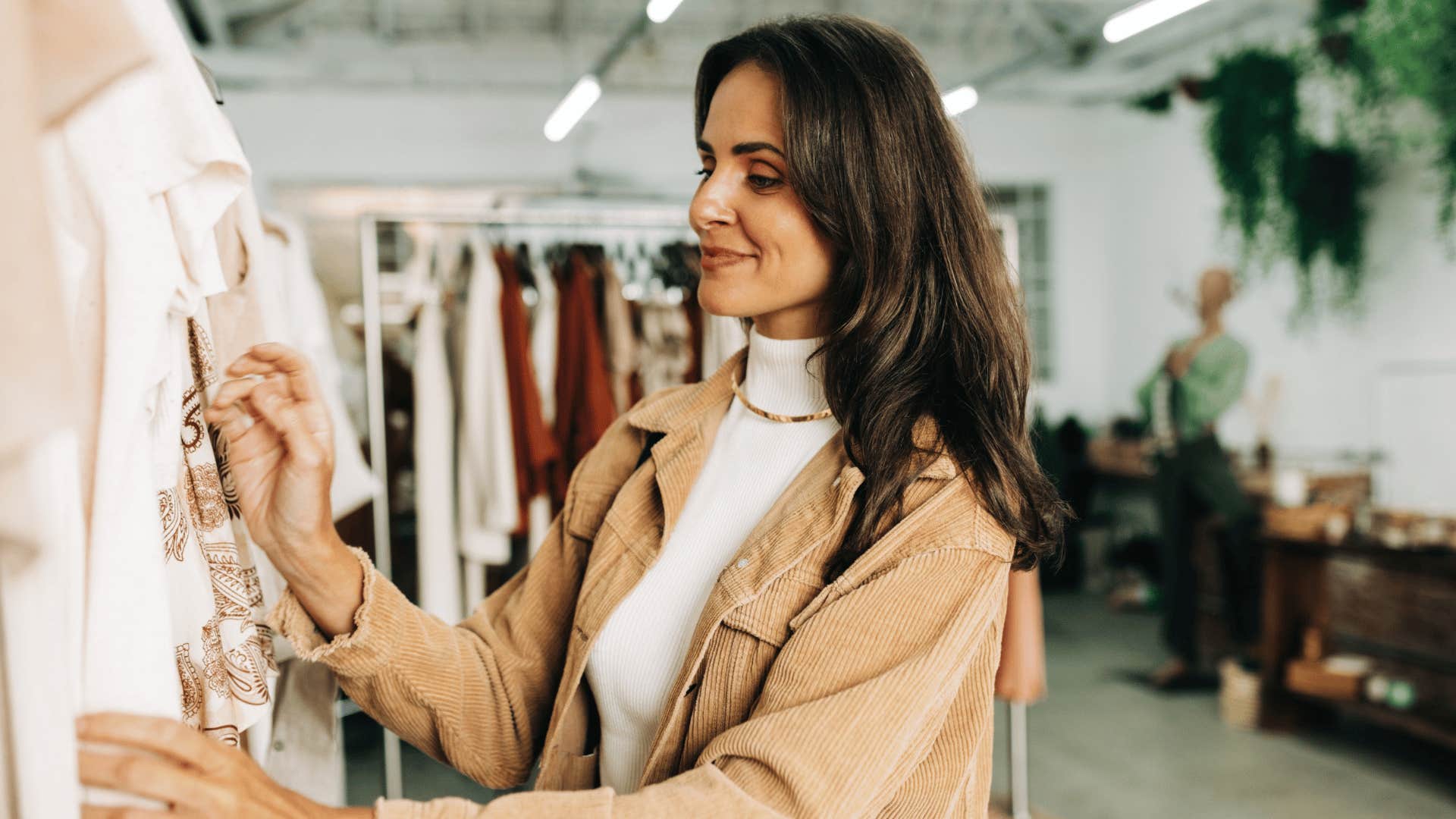 woman looking at clothing on the rack