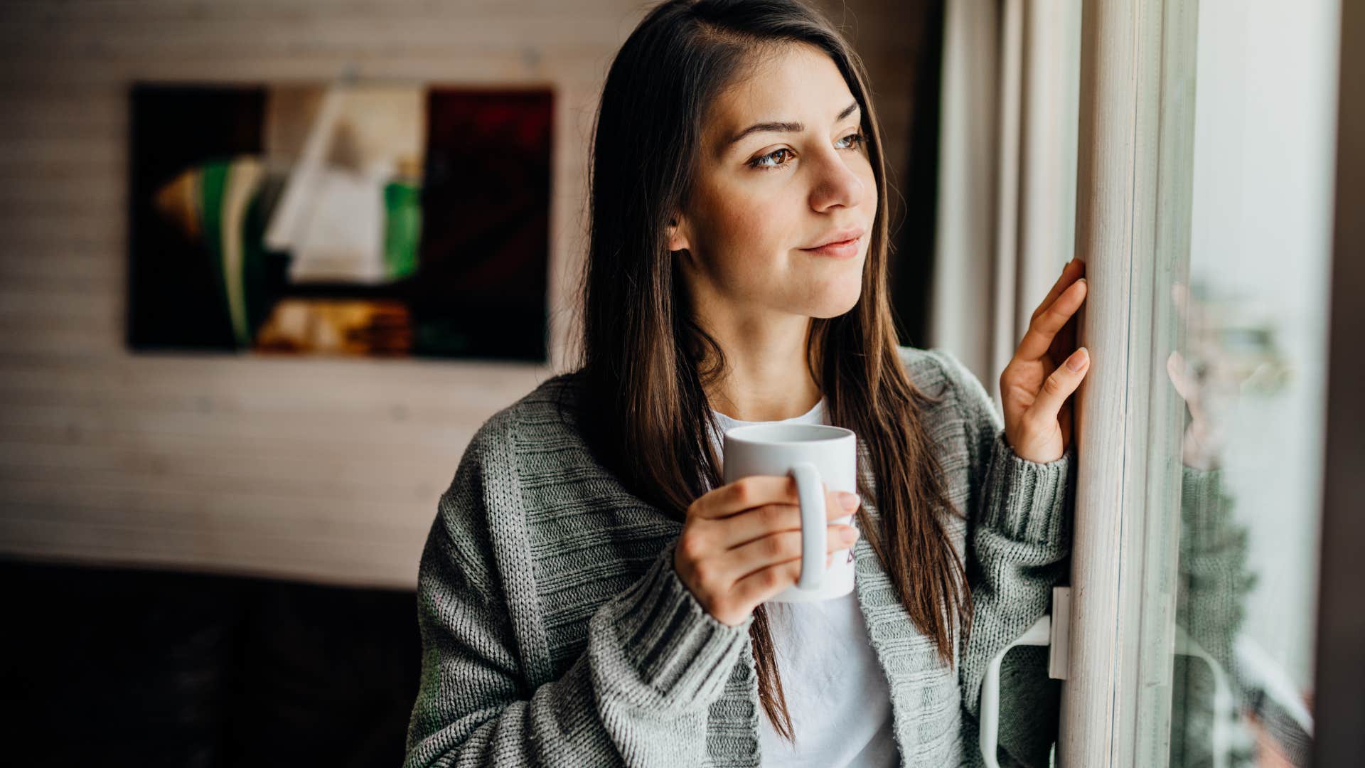 positive woman looking out a window