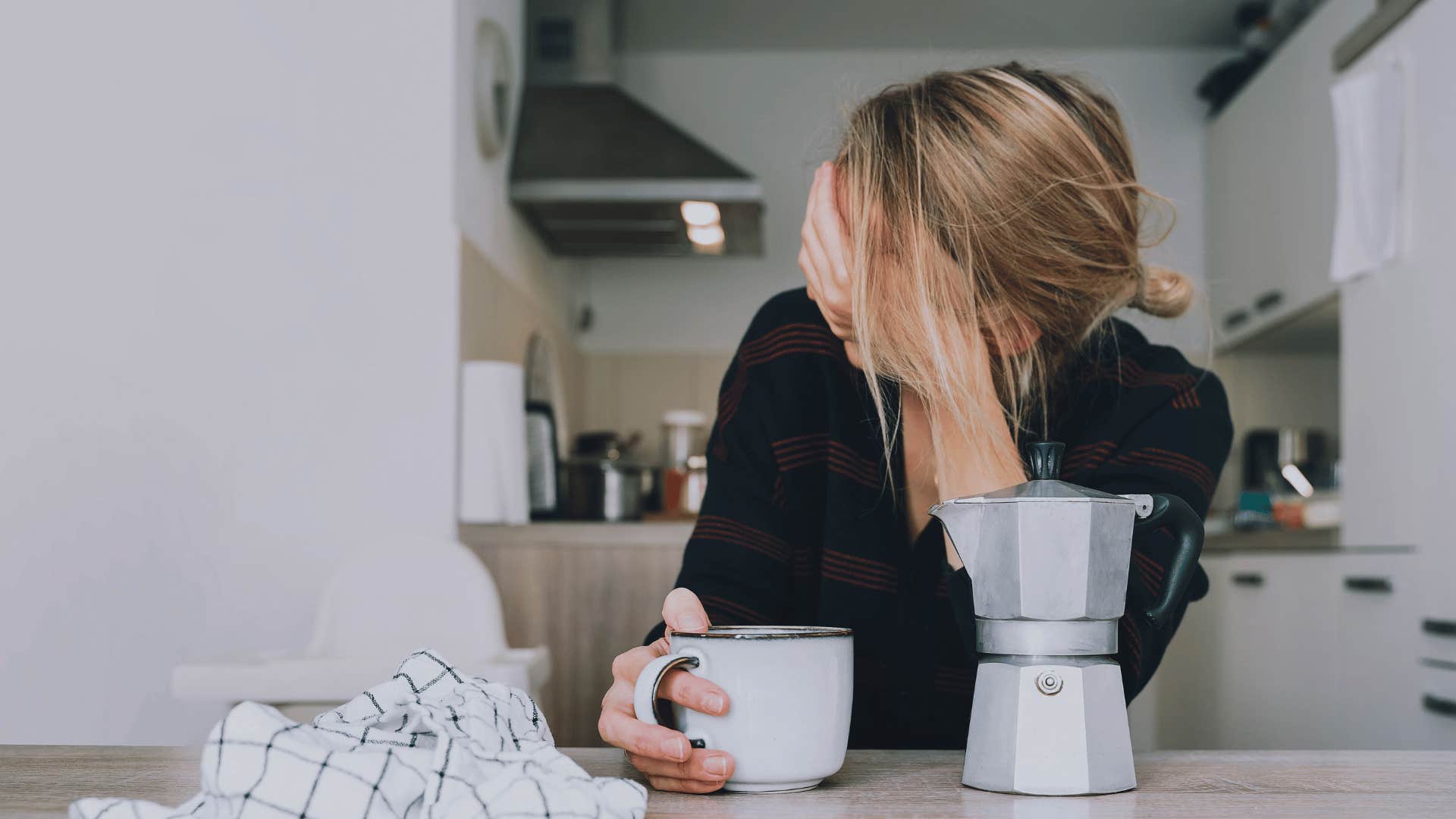 tired woman in kitchen