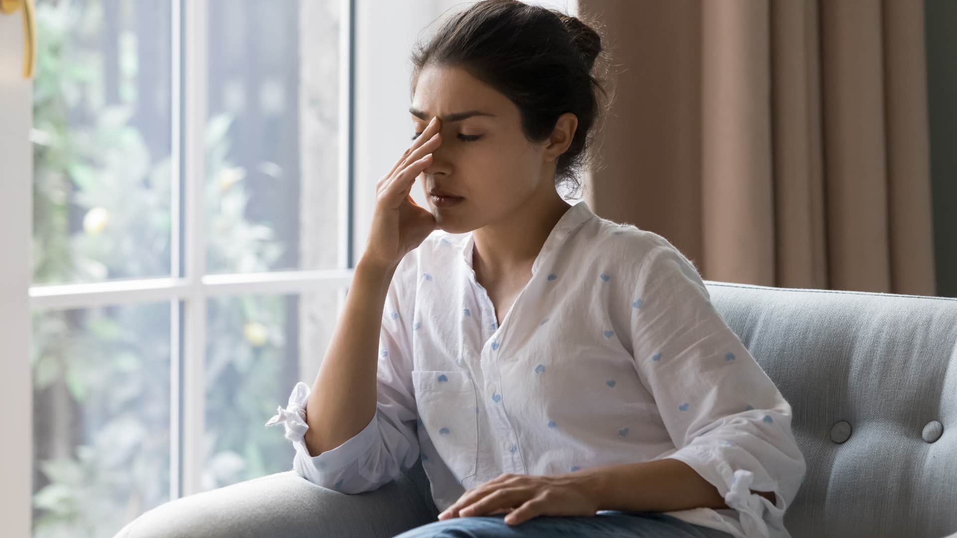 stressed out woman sitting on couch