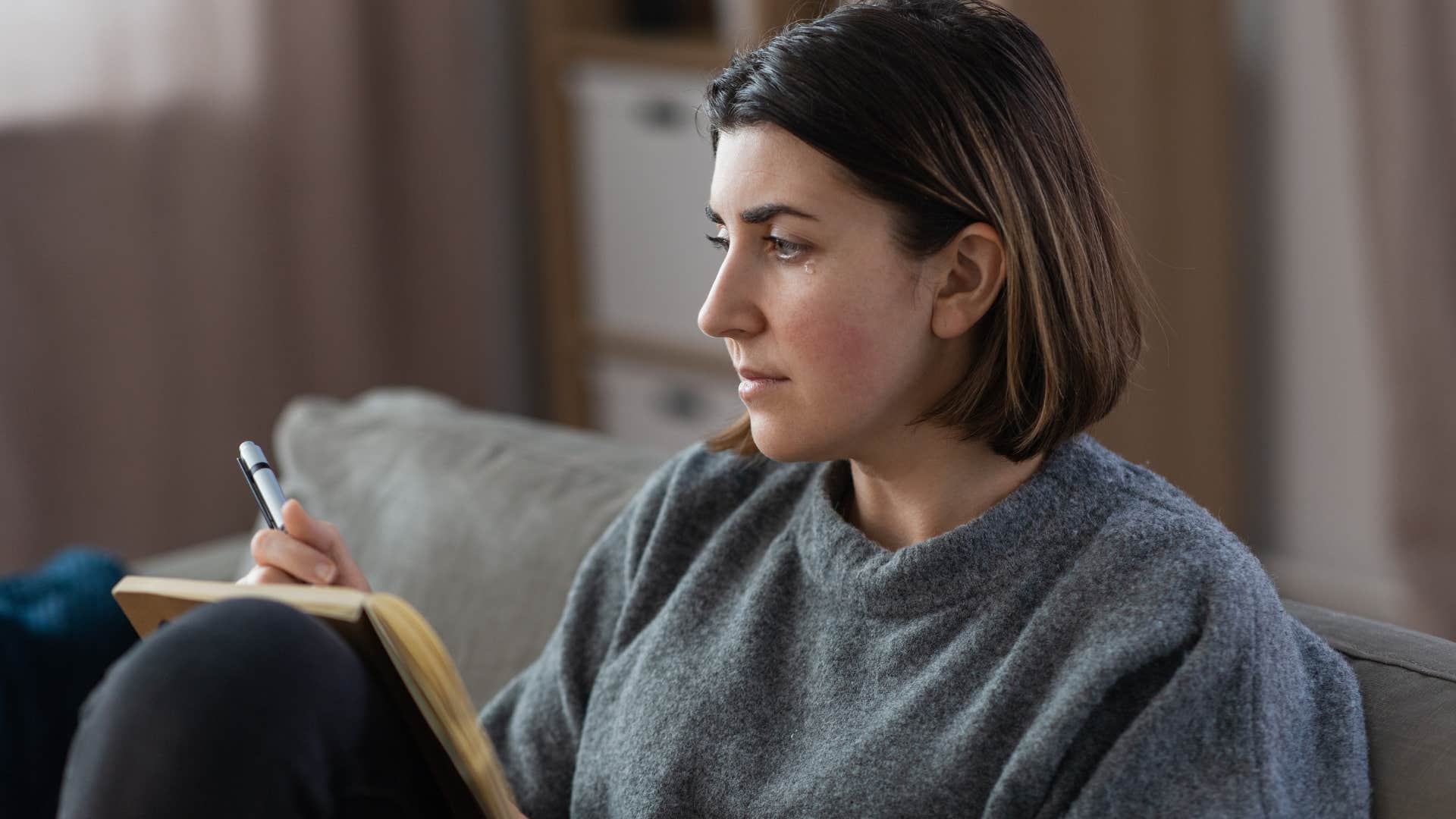 serious woman writing in journal