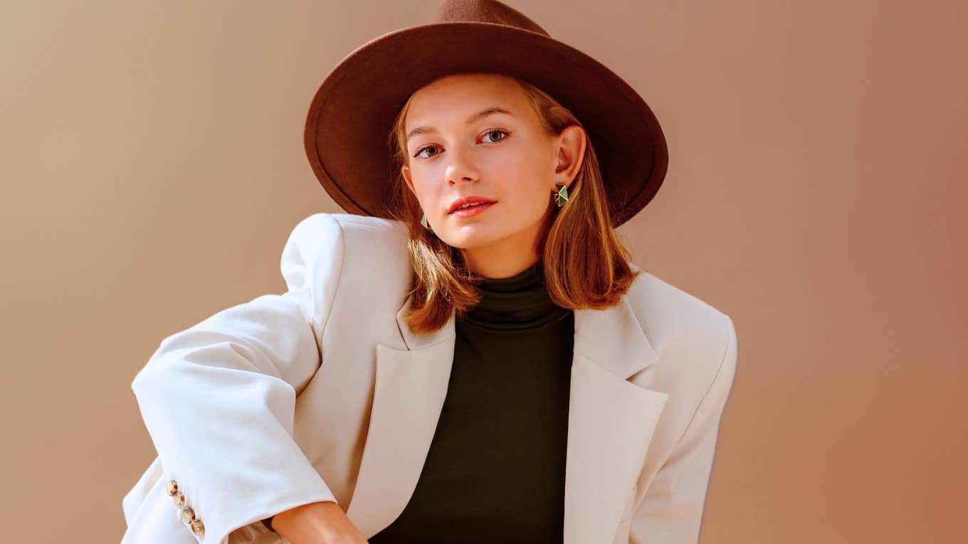 Brilliant young woman in hat using anger to get what they want