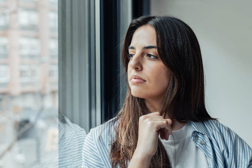 woman looking out window