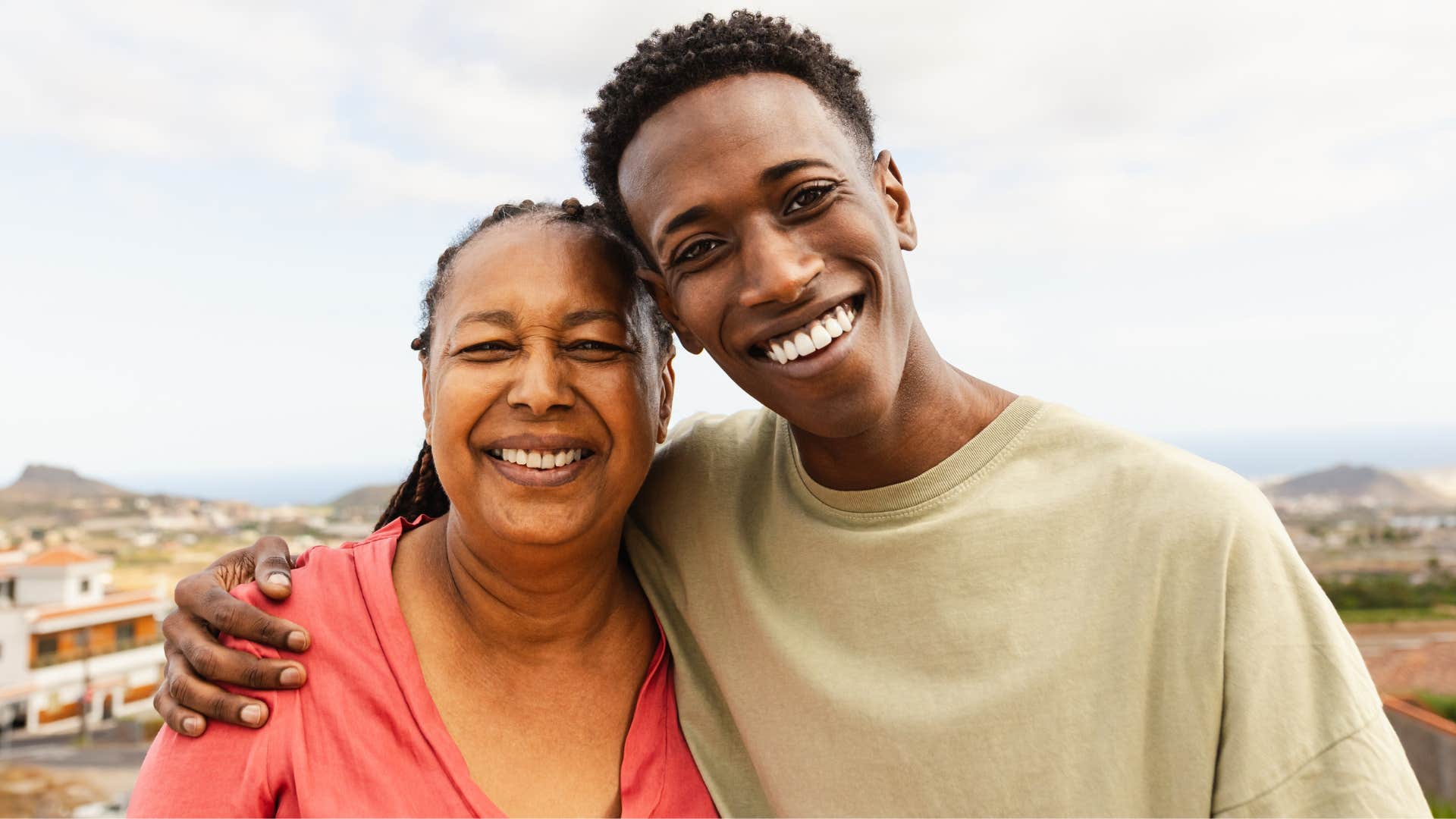 teenage boy smiling hugging his grandmother