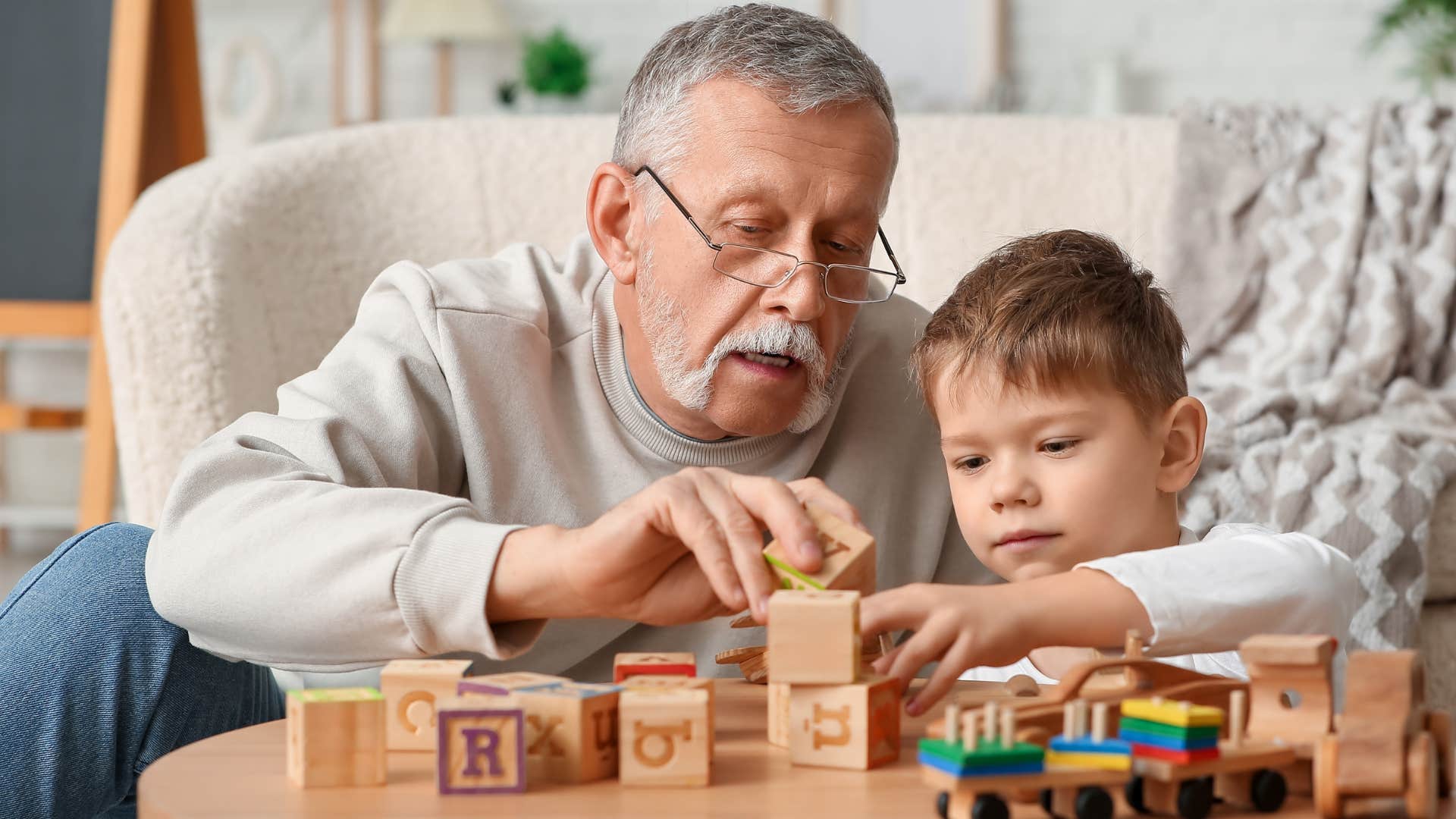 grandfather playing a game with young grandson