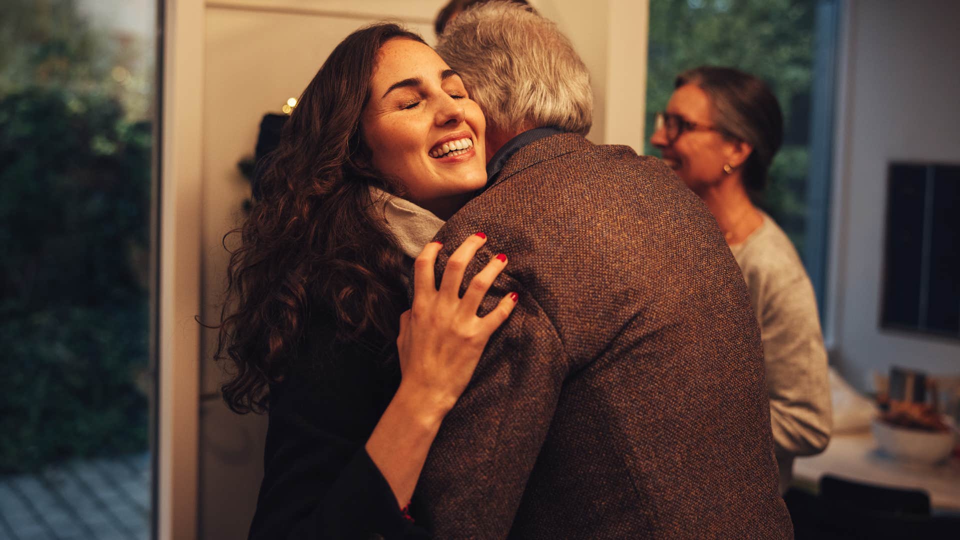 young woman smiling and hugging her grandfather