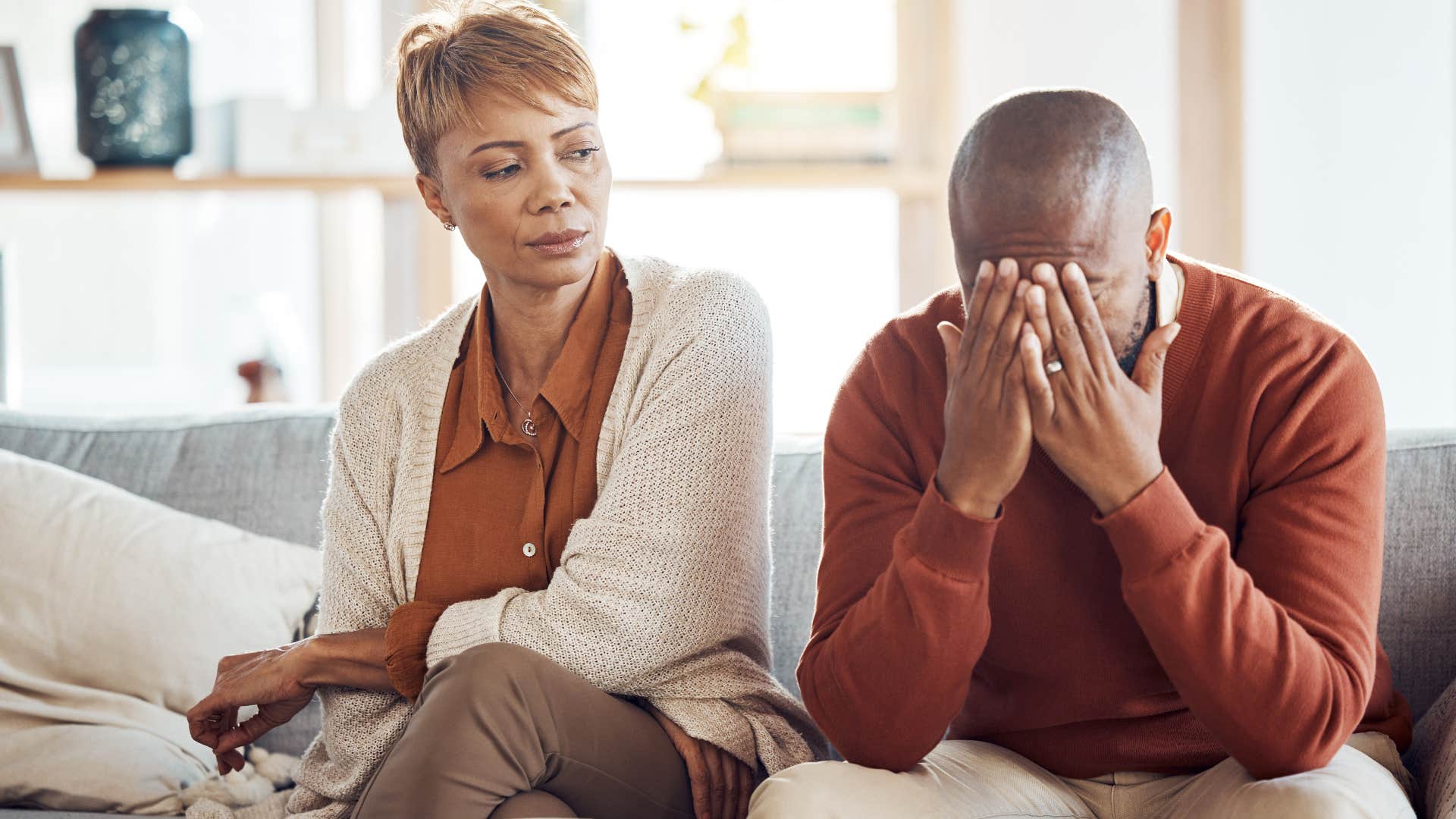 Boomer couple looking upset sitting next to each other