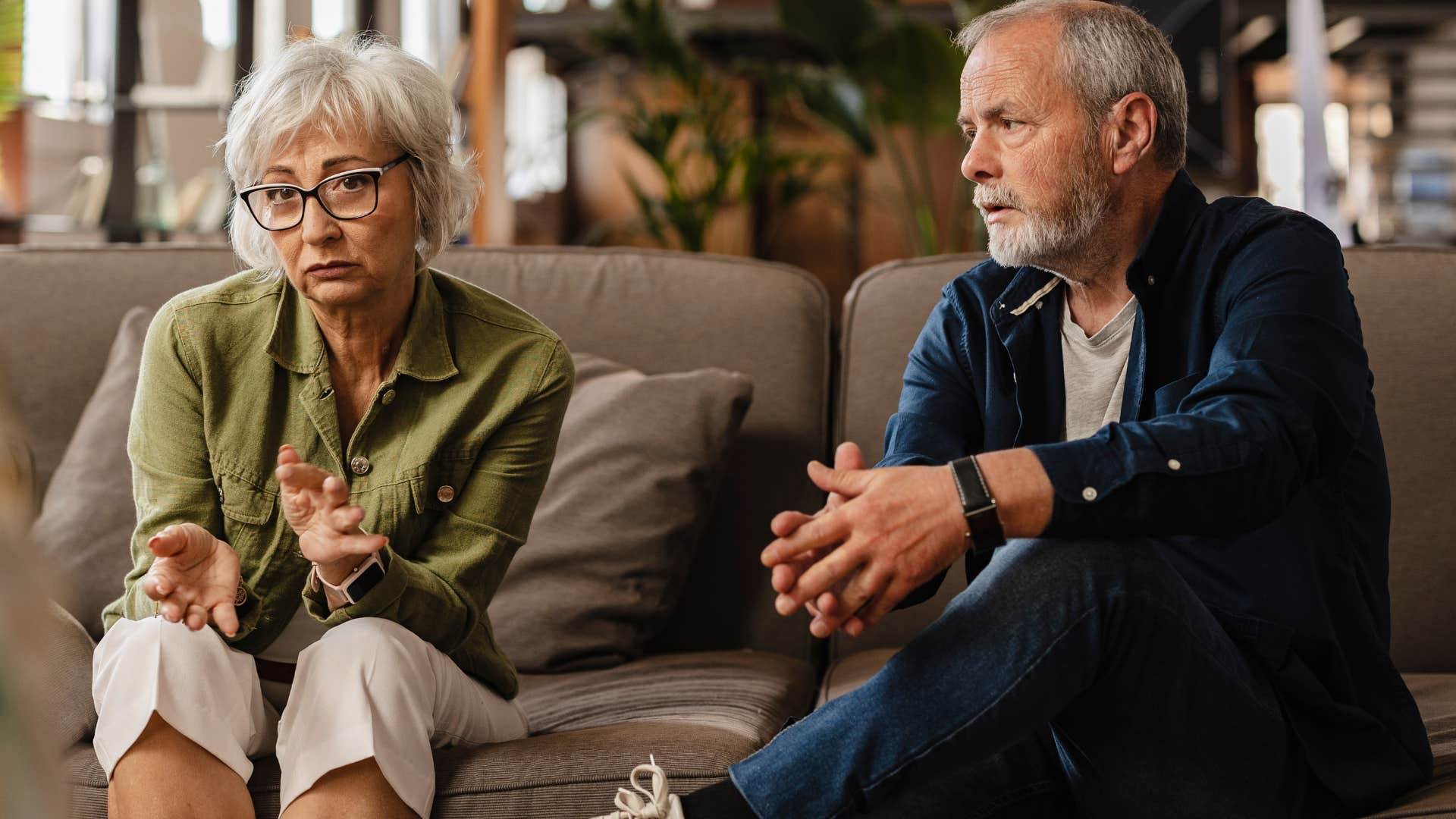 Older couple talking with a therapist on a couch