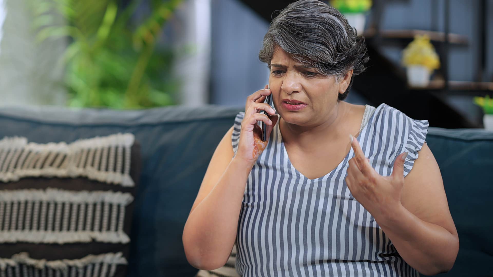 Older woman looking upset talking on the phone