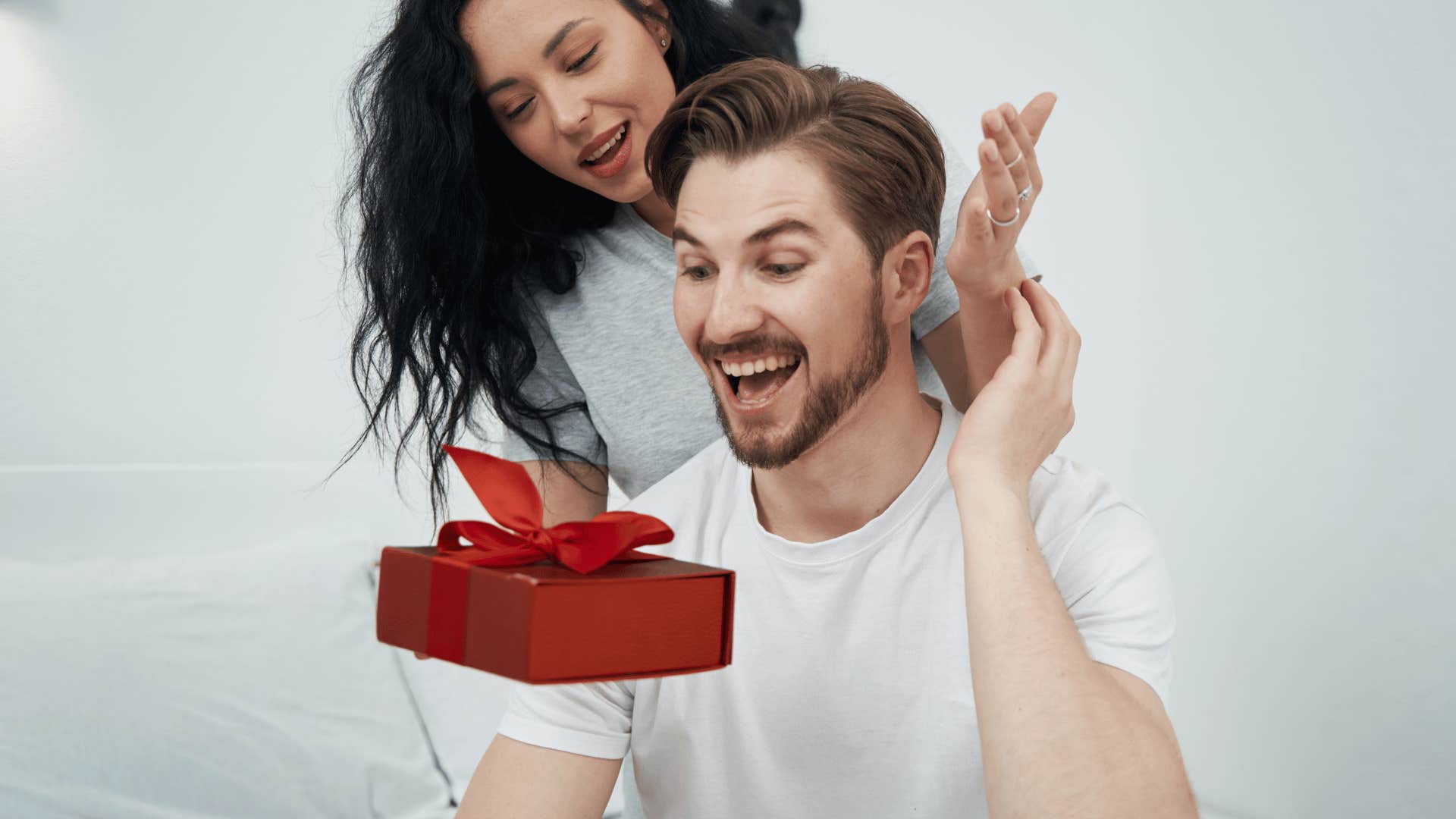 woman giving man a gift