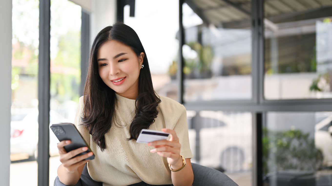 financially successful woman holding her credit card