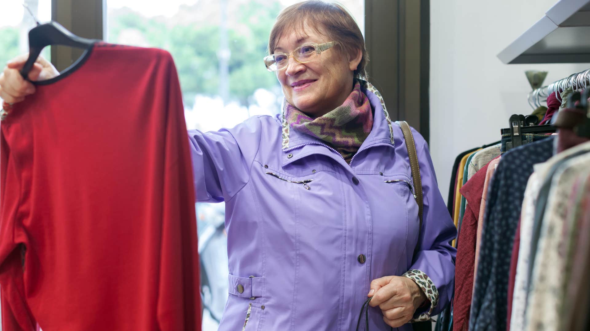 smiling older woman shopping for clothes