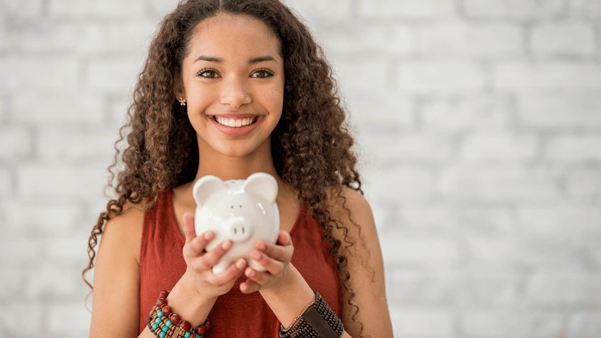 Gen Z woman with piggy bank for savings account