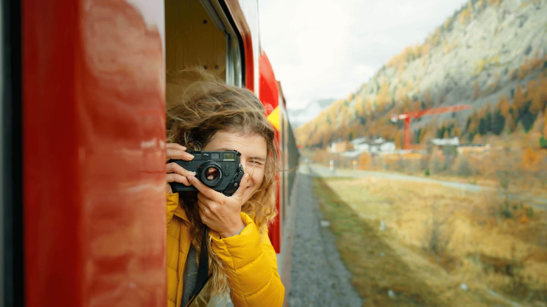 Woman with camera on train