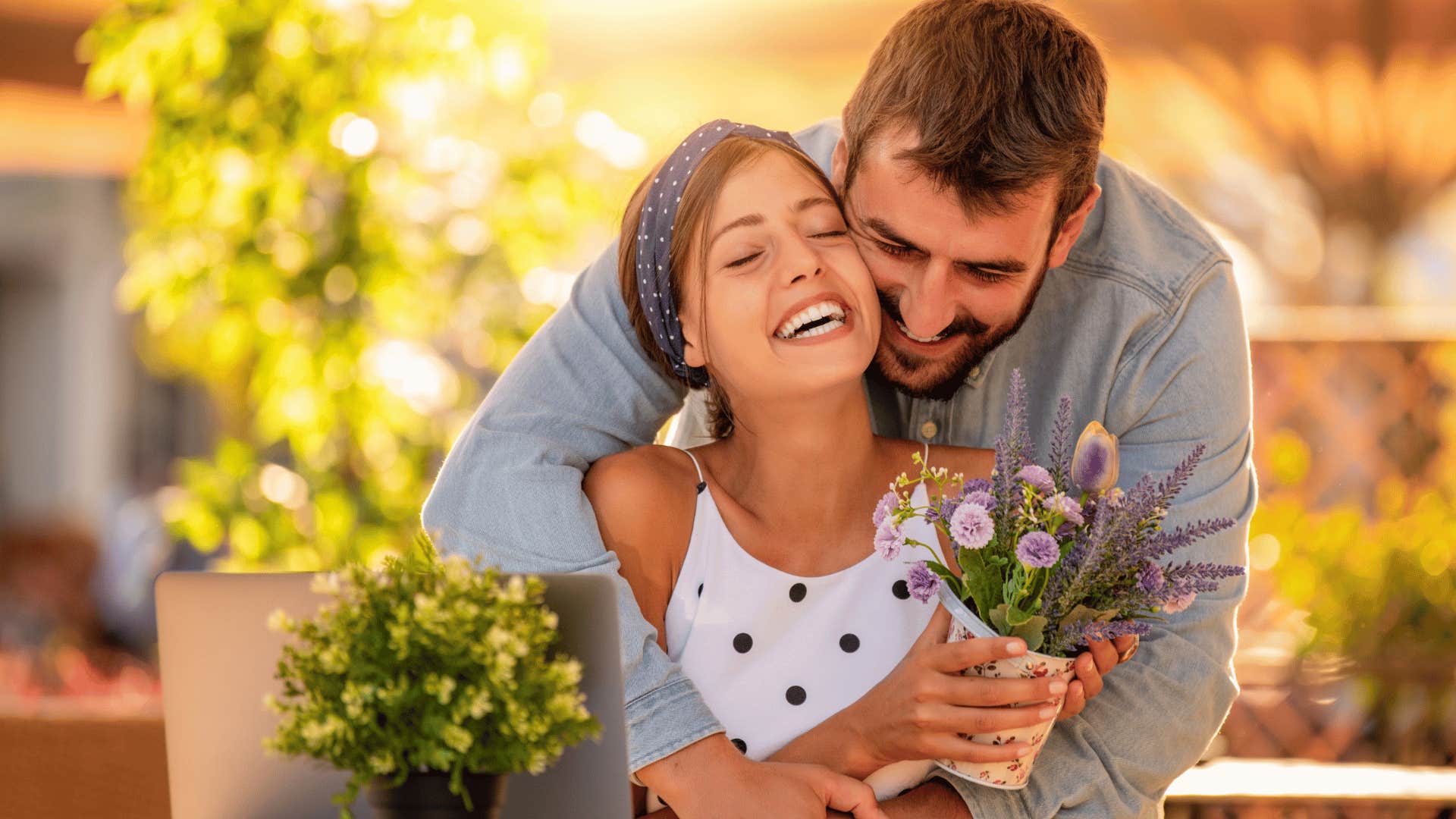 loving man hugging wife from behind