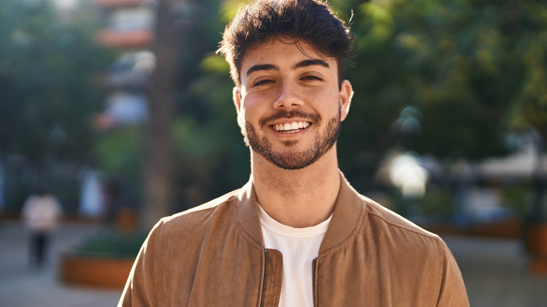 arrogant young man standing in street