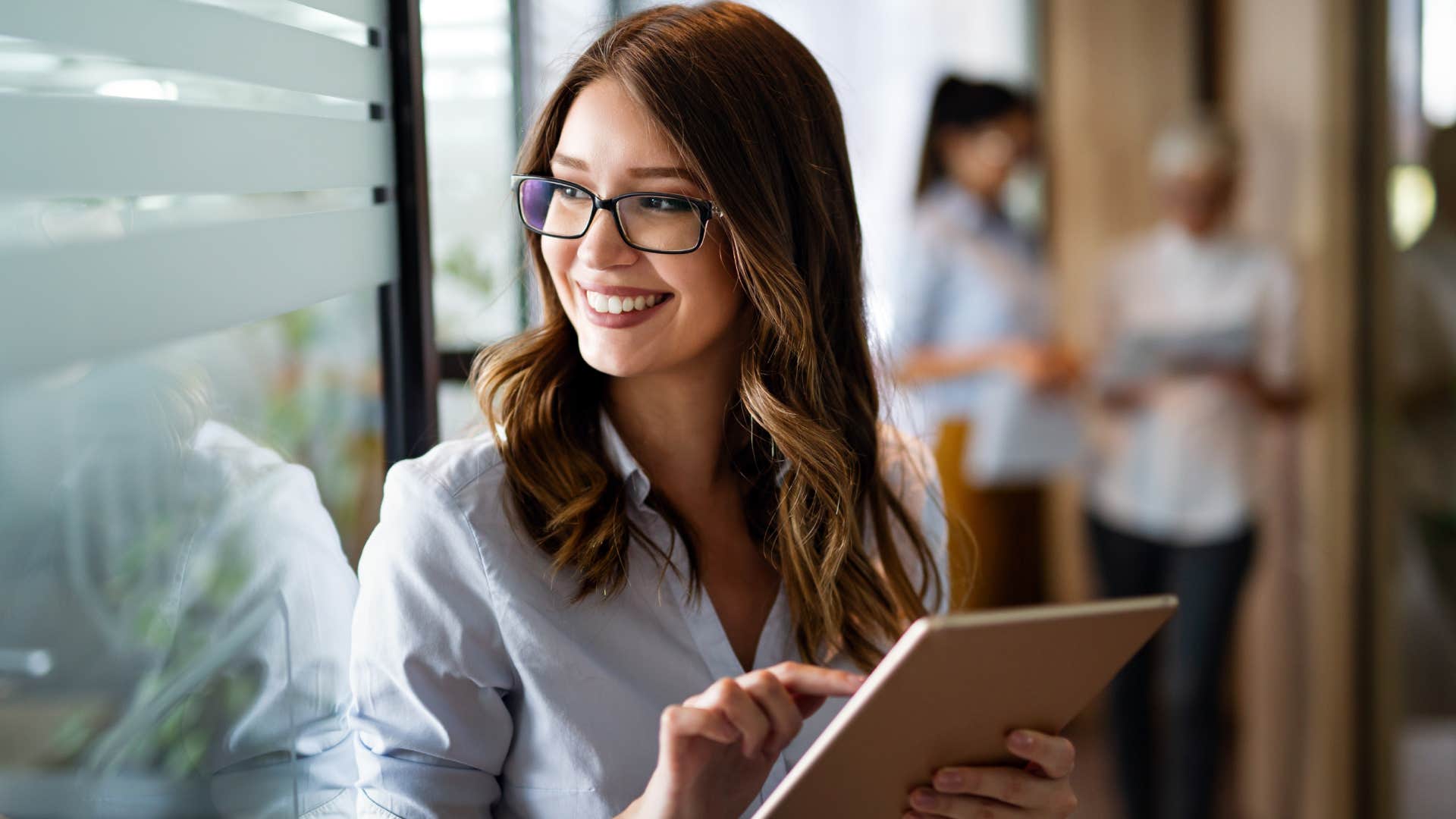 middle class woman working long-term career on tablet at work