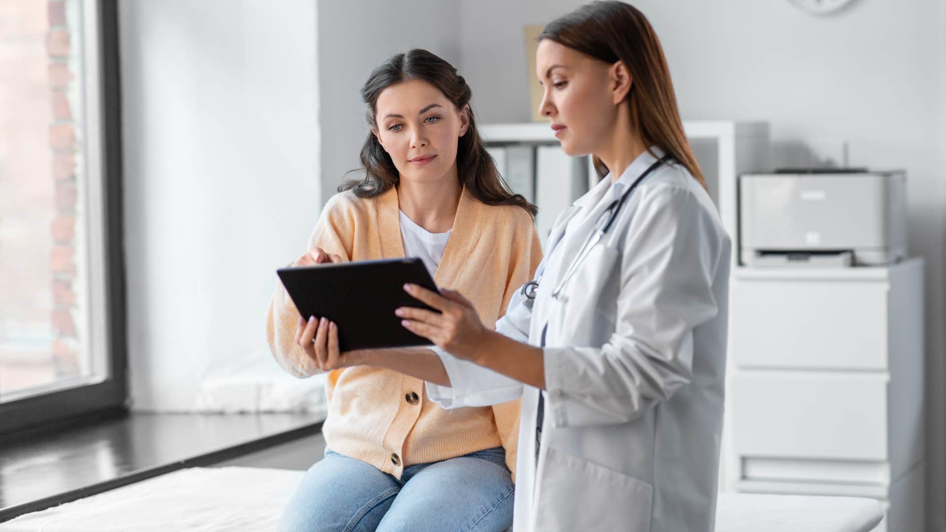 middle class woman talking to doctor about her health