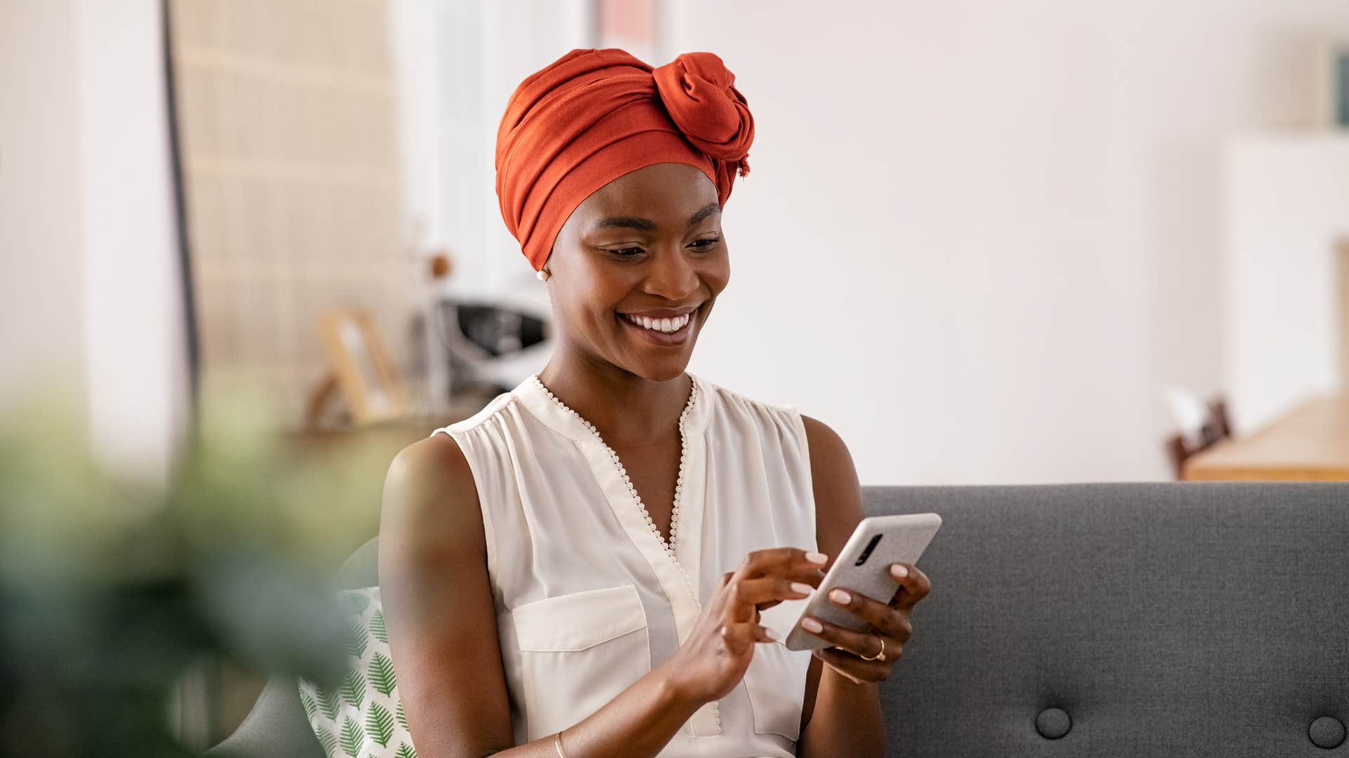 middle class woman smiling while using technology