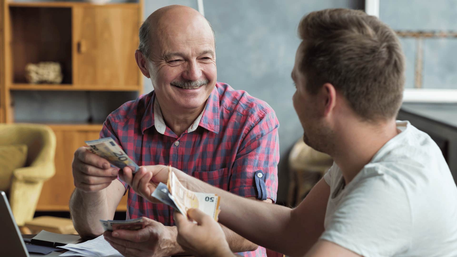 father lending adult son money