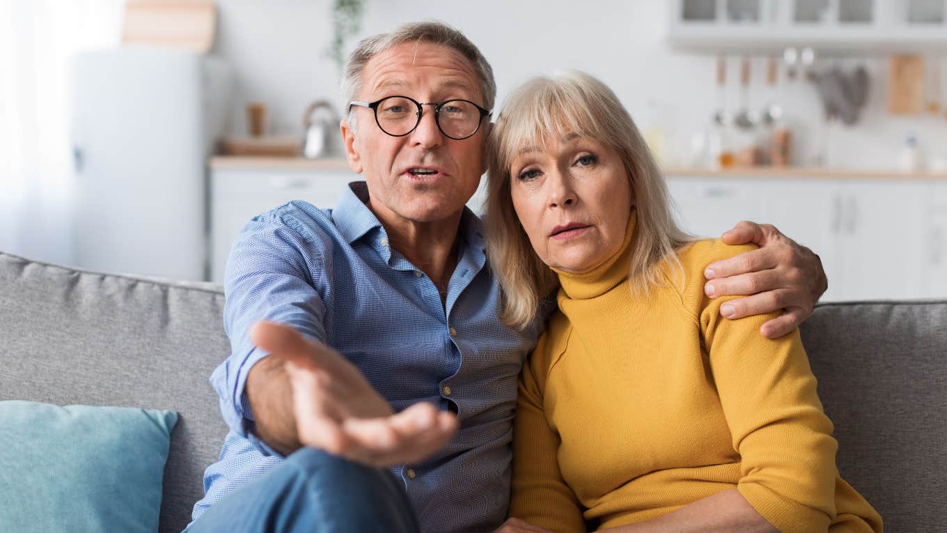 older parents sitting on couch talking