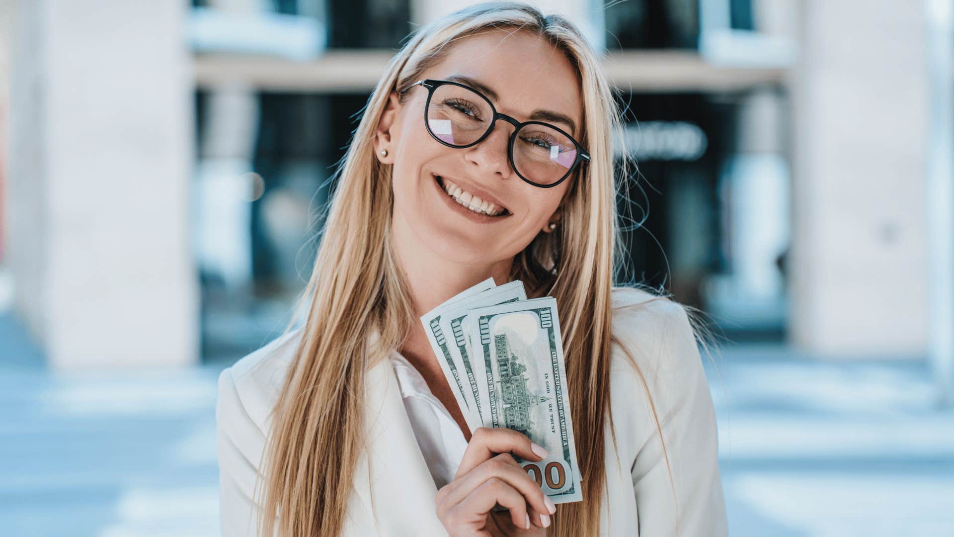 happy woman holding cash