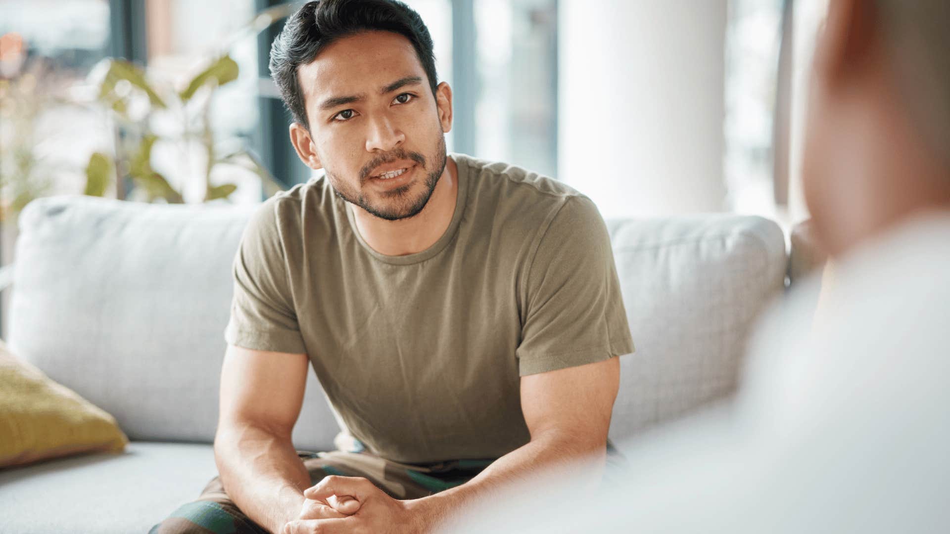 man sitting in therapy session