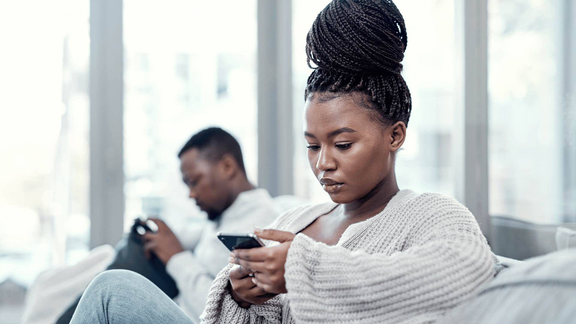 serious woman waiting to text back