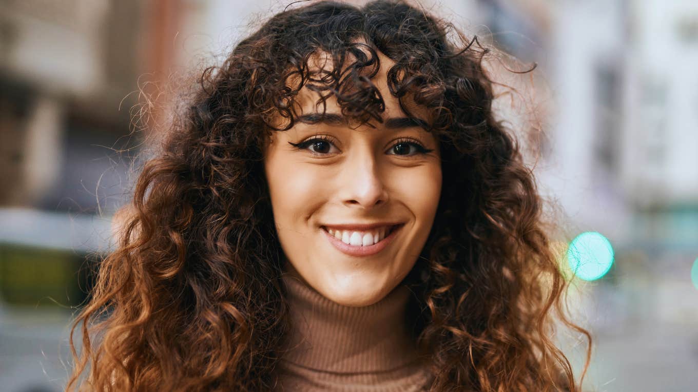 happy young woman smiling big