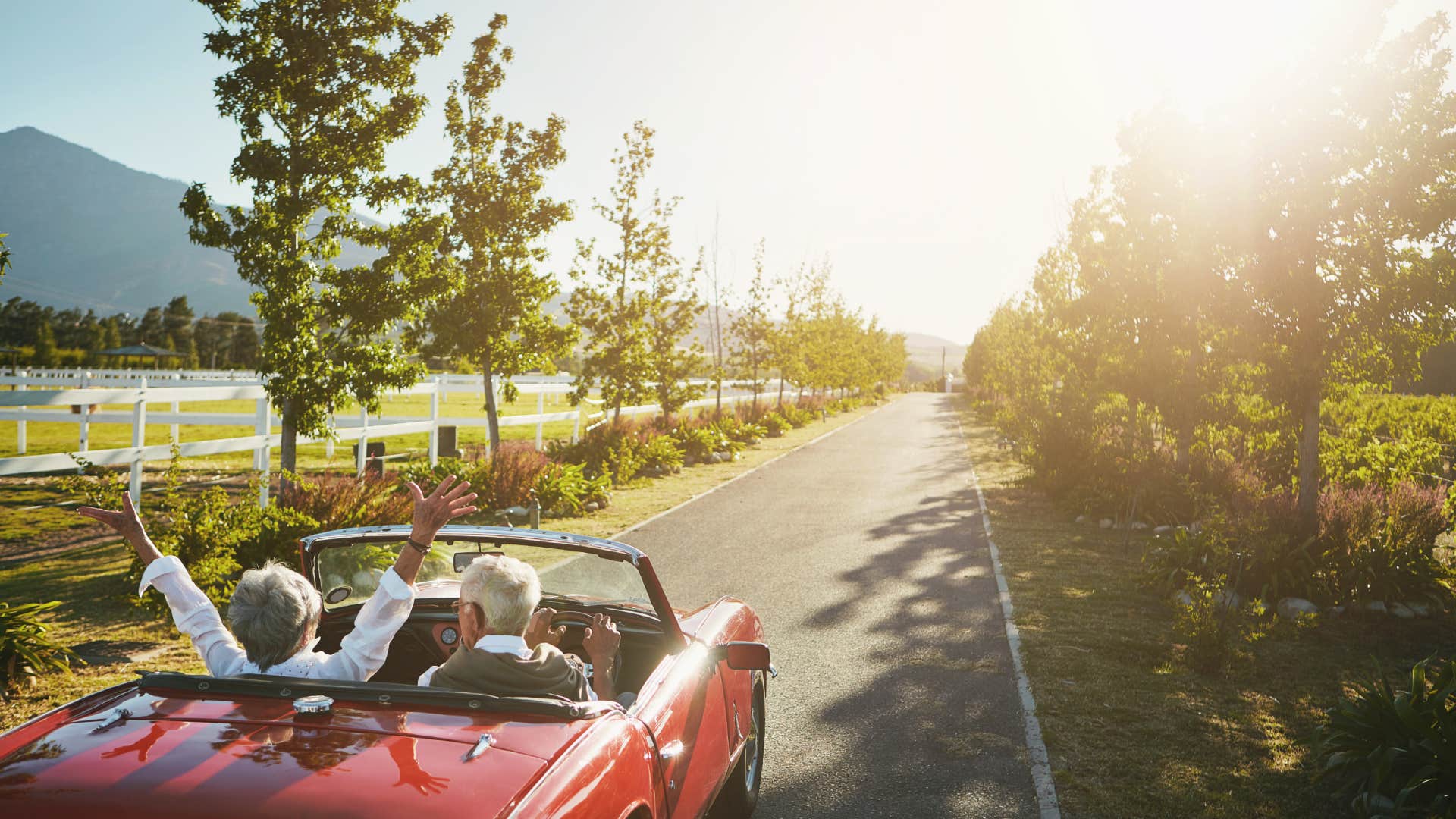 couple driving in luxury car on road