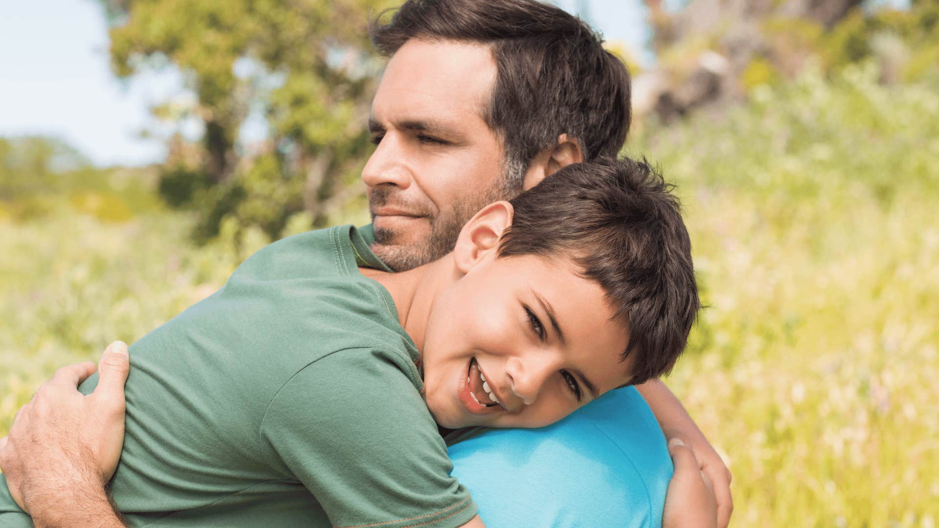 Calm father hugs happy child