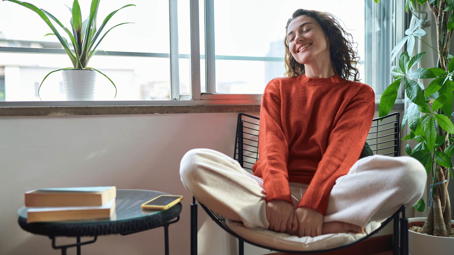 woman smiling and sitting on chair