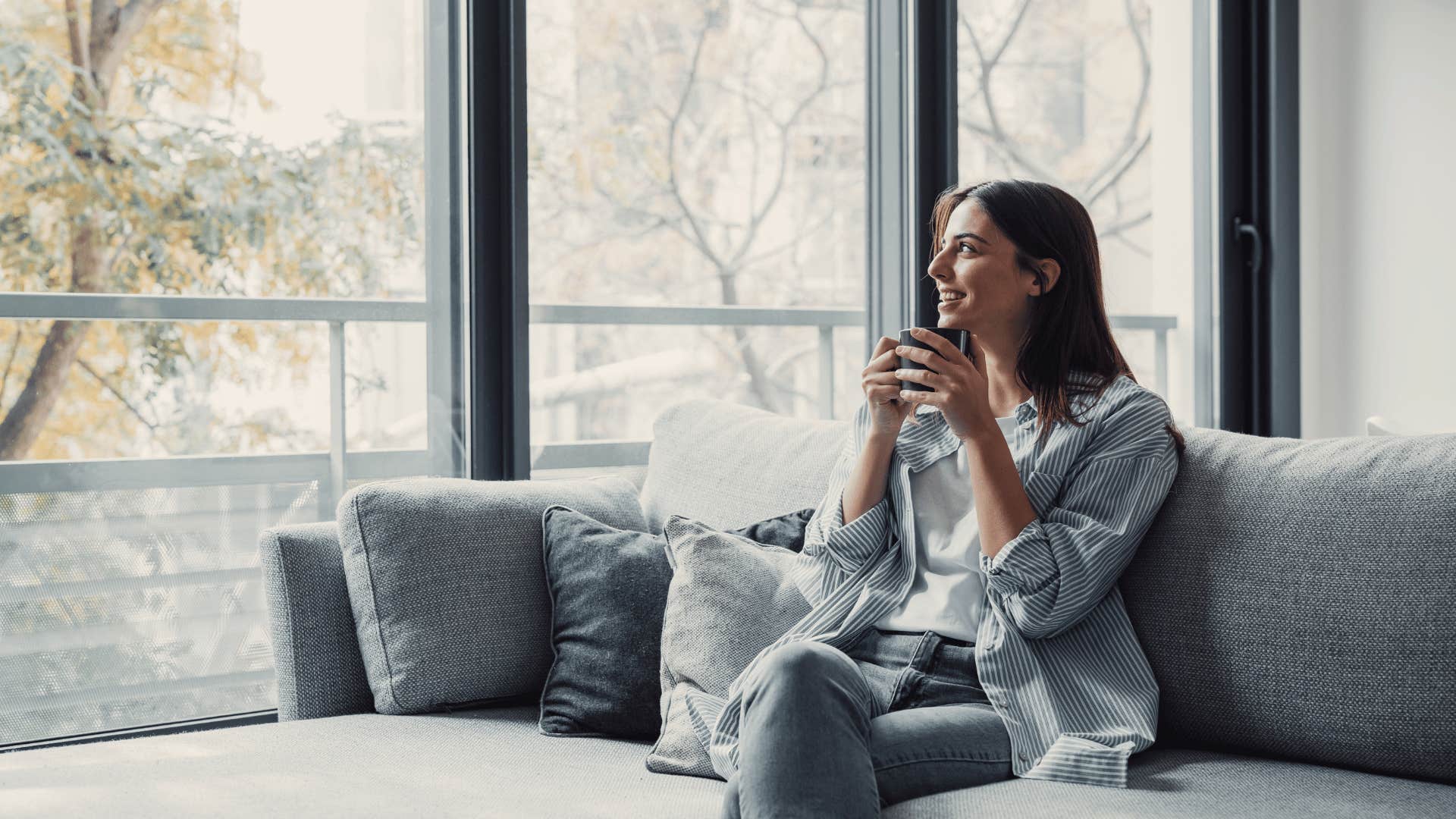 woman smiling and drinking coffee