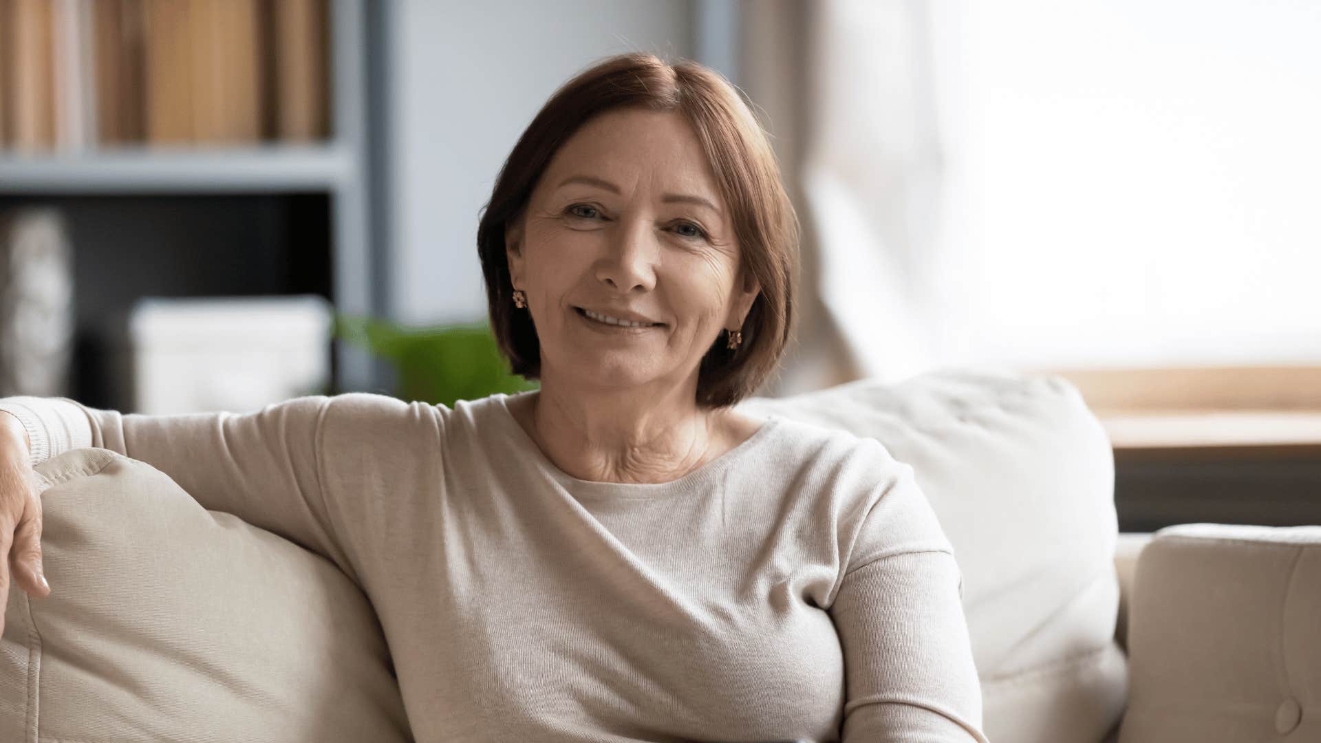 smiling older woman sitting on couch