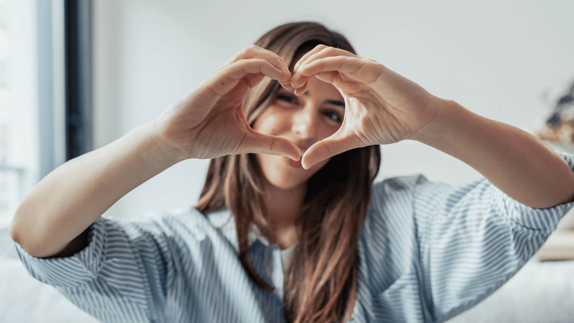 woman making a heart with her hands