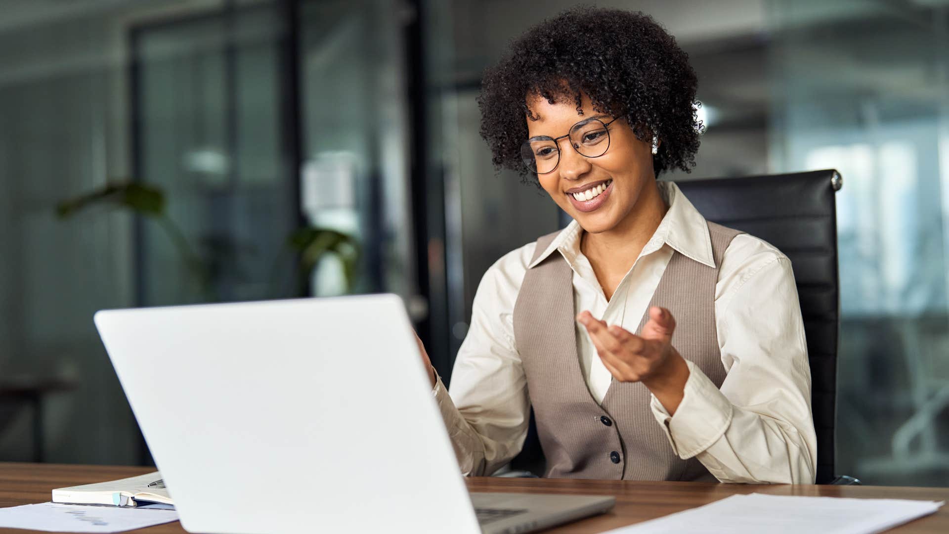 Happy woman smiling while asking for documentation at work