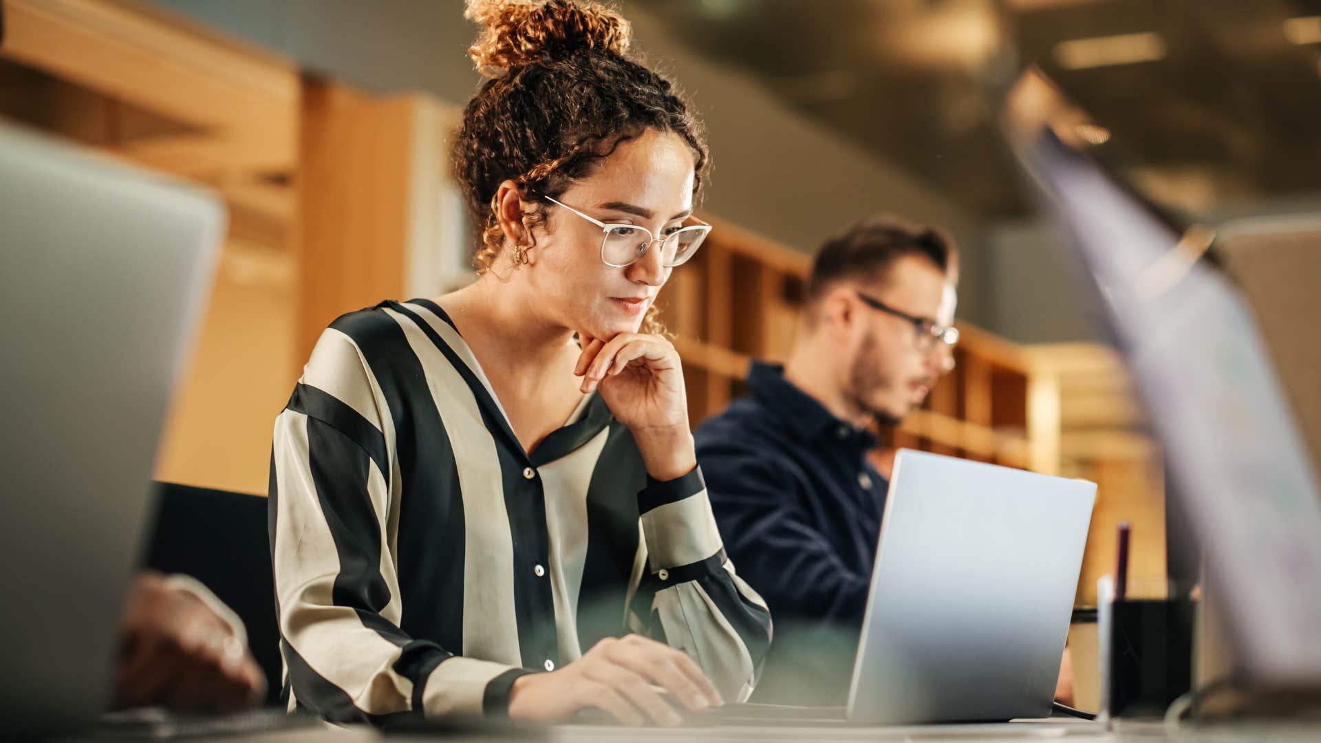 Young woman working on her laptop with education assistance from work