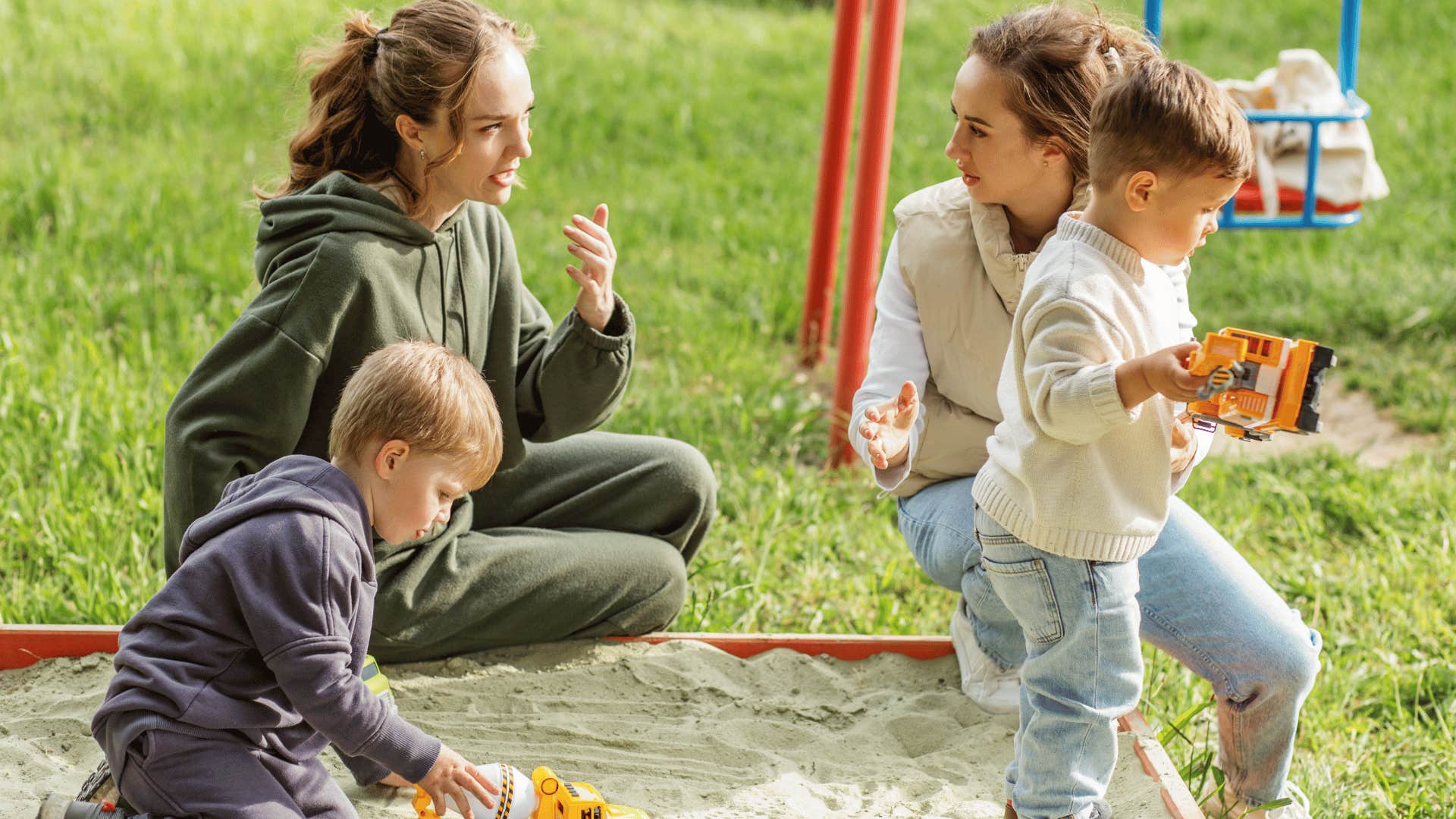 mothers talking on playground with their kids