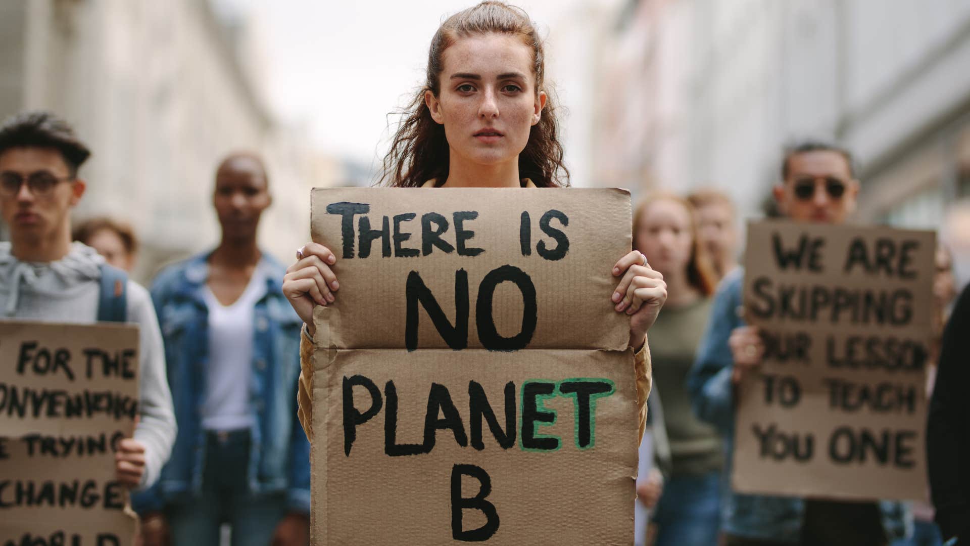 Gen Z woman holding a climate activism sign