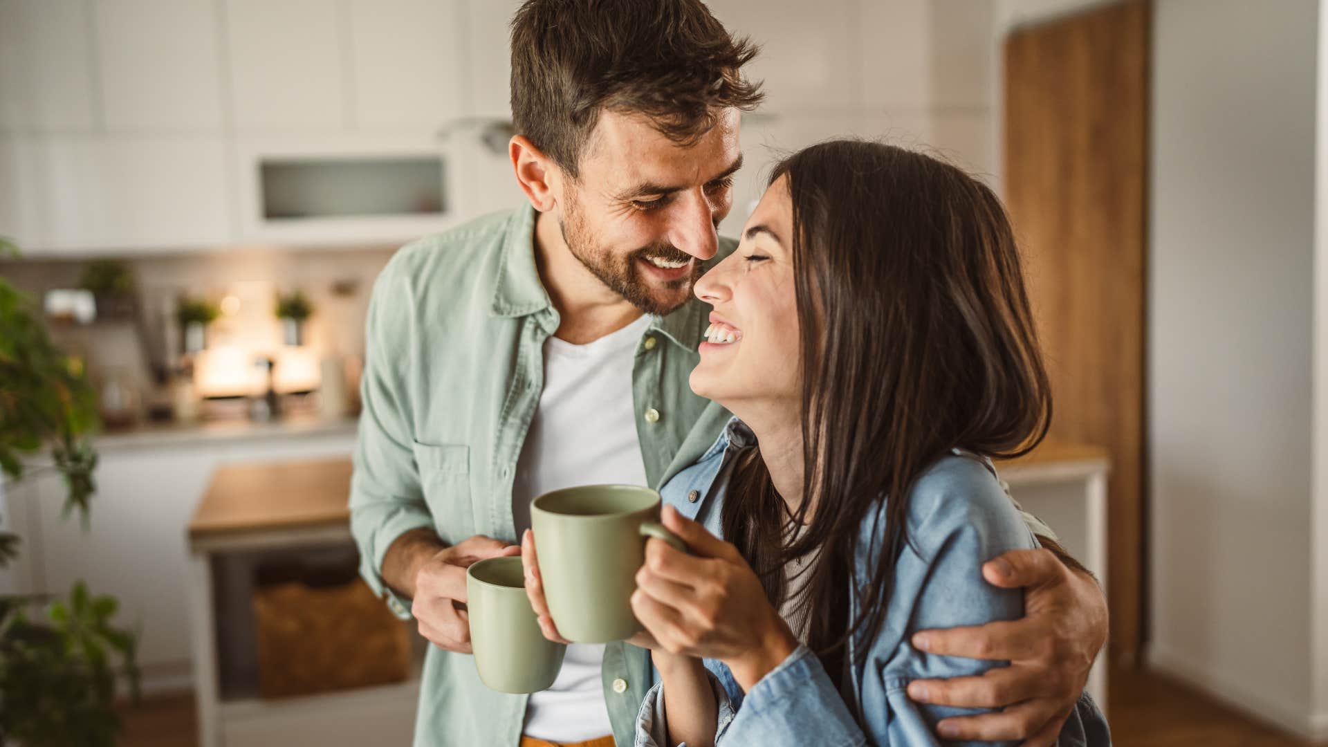 young couple smiling and hugging each other