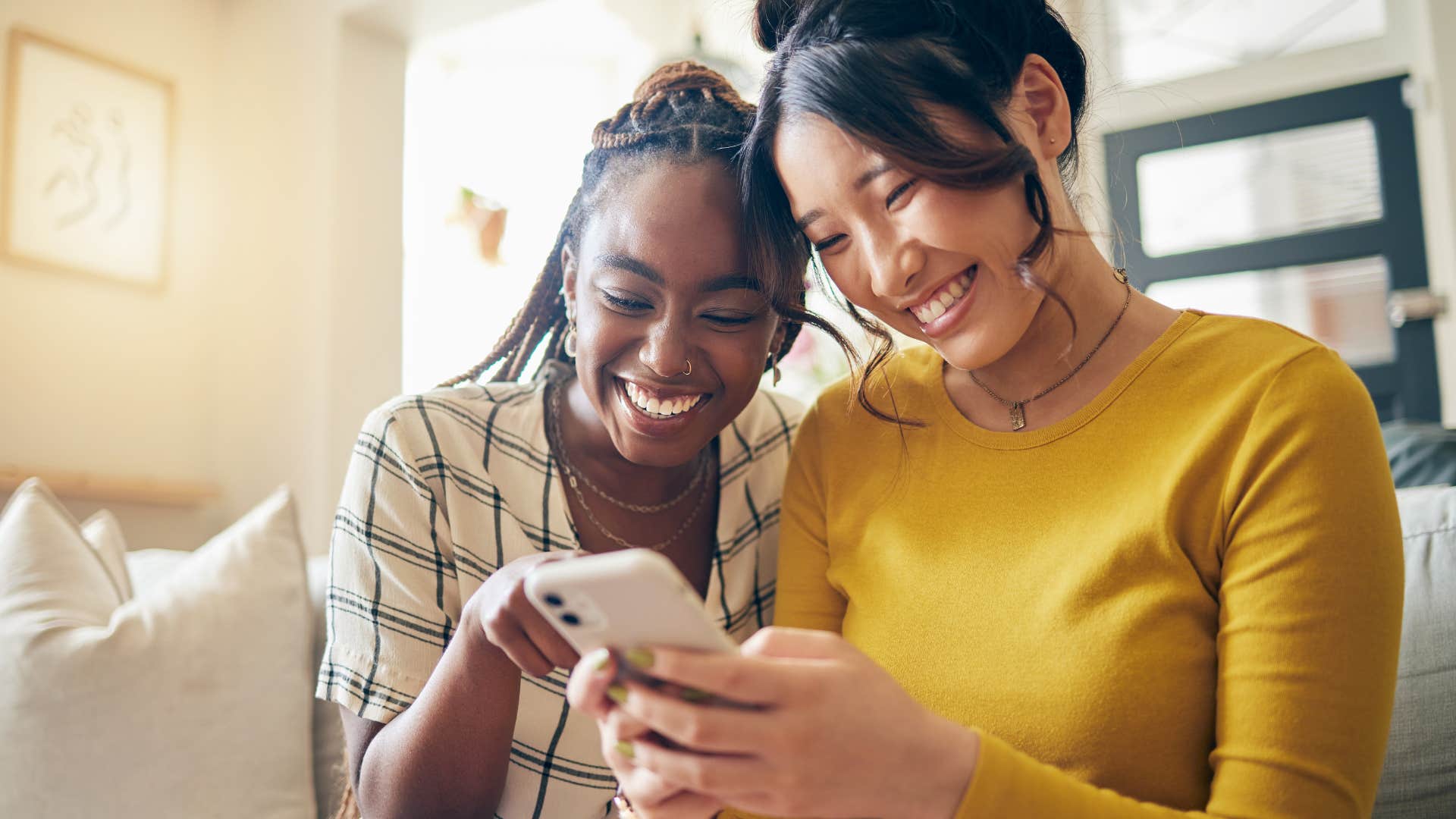 two young women looking at a phone