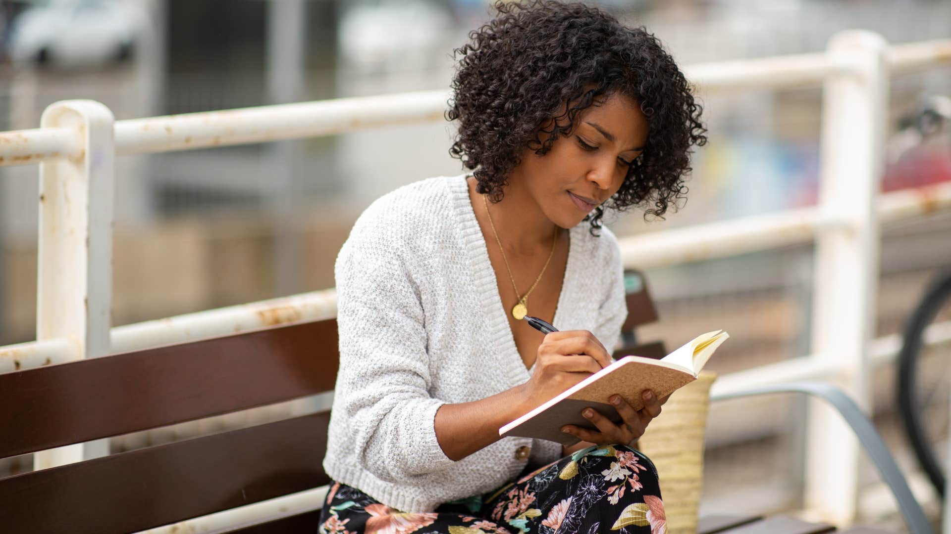 woman writing in journal to overcome negative thoughts